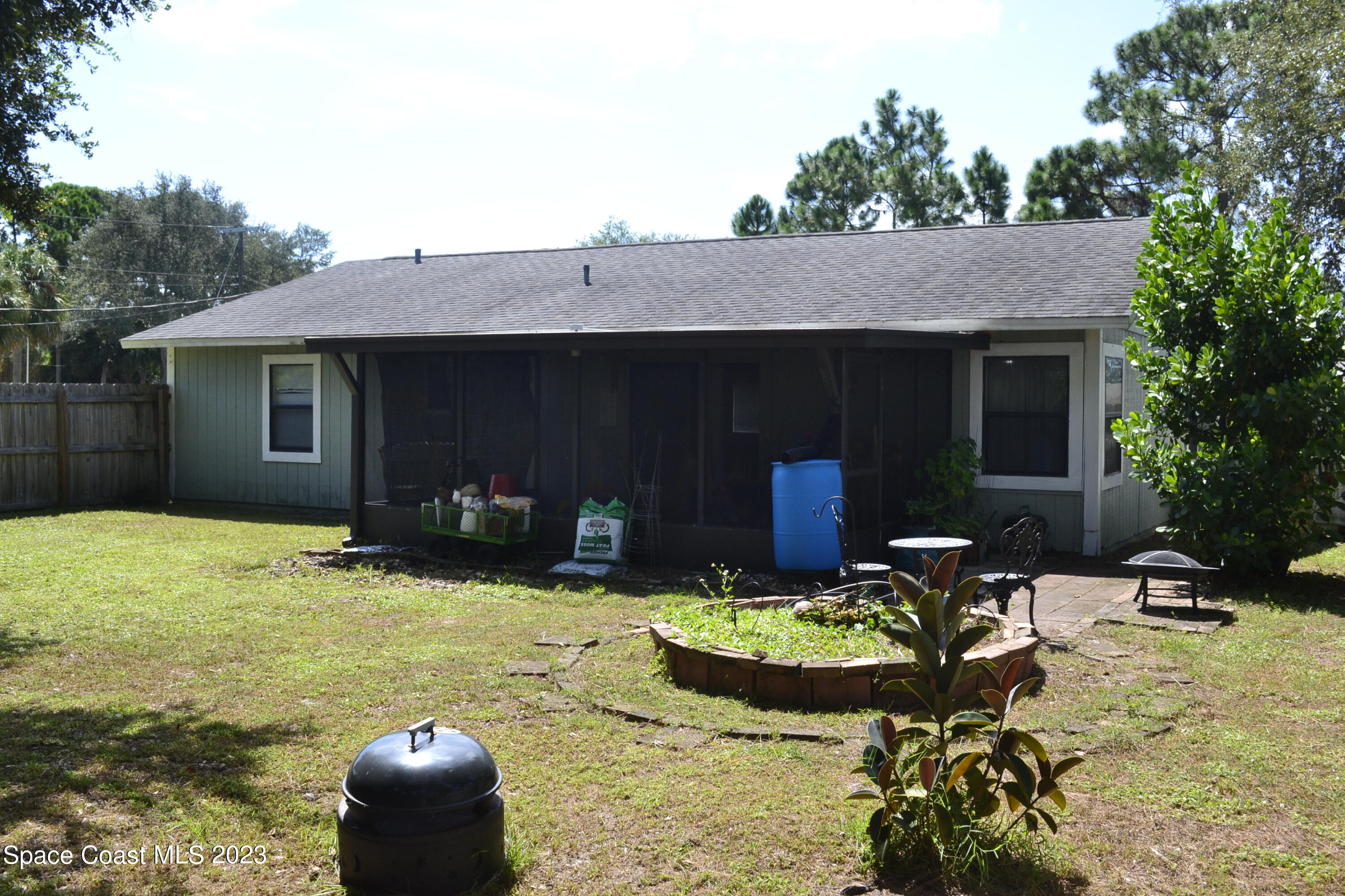 3910 Delespine Road Cocoa, FL 32927 - Photo 20 of 21 a front view of house with yard seating and green space