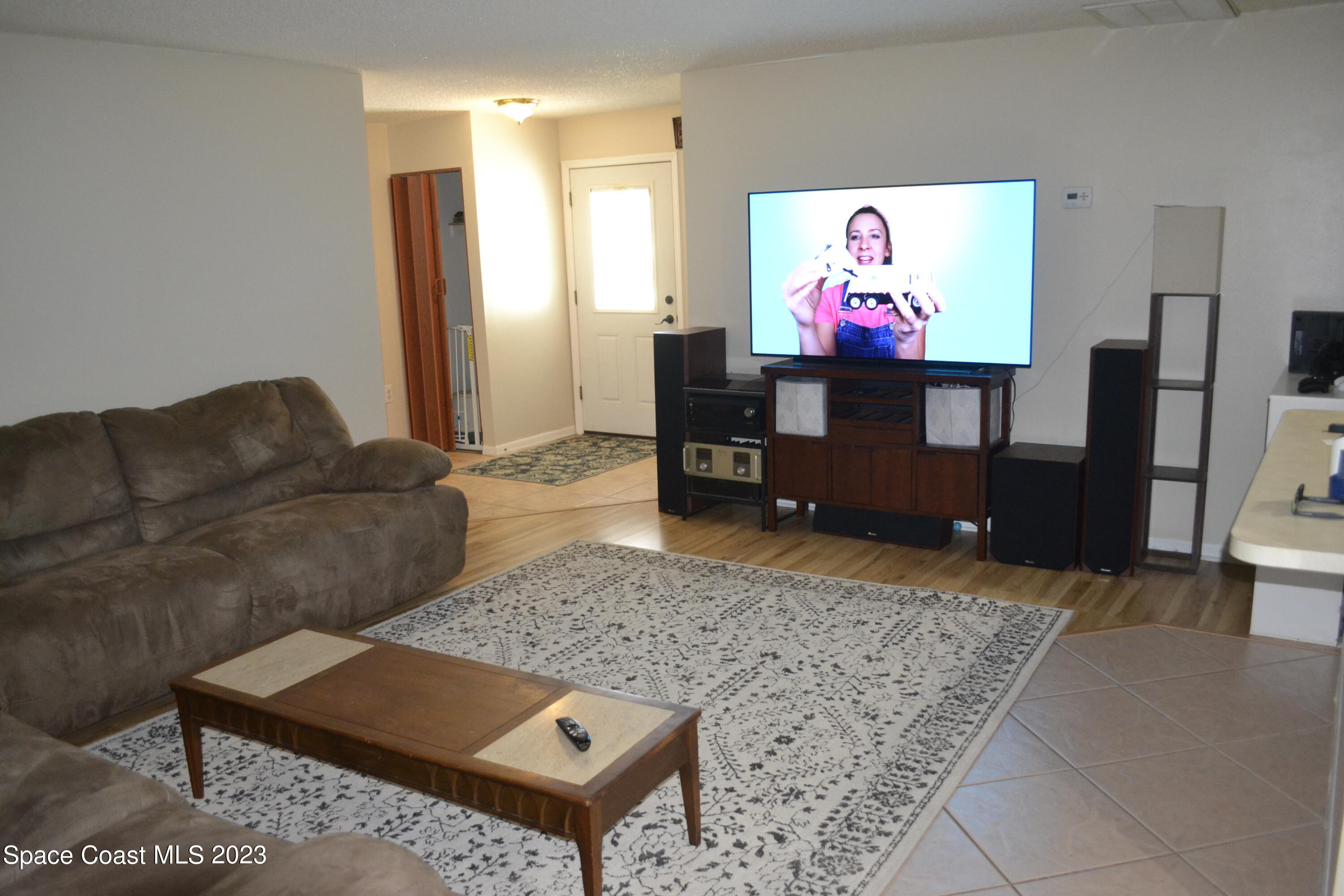 3910 Delespine Road Cocoa, FL 32927 - Photo 8 of 21 a living room with furniture and a flat screen tv