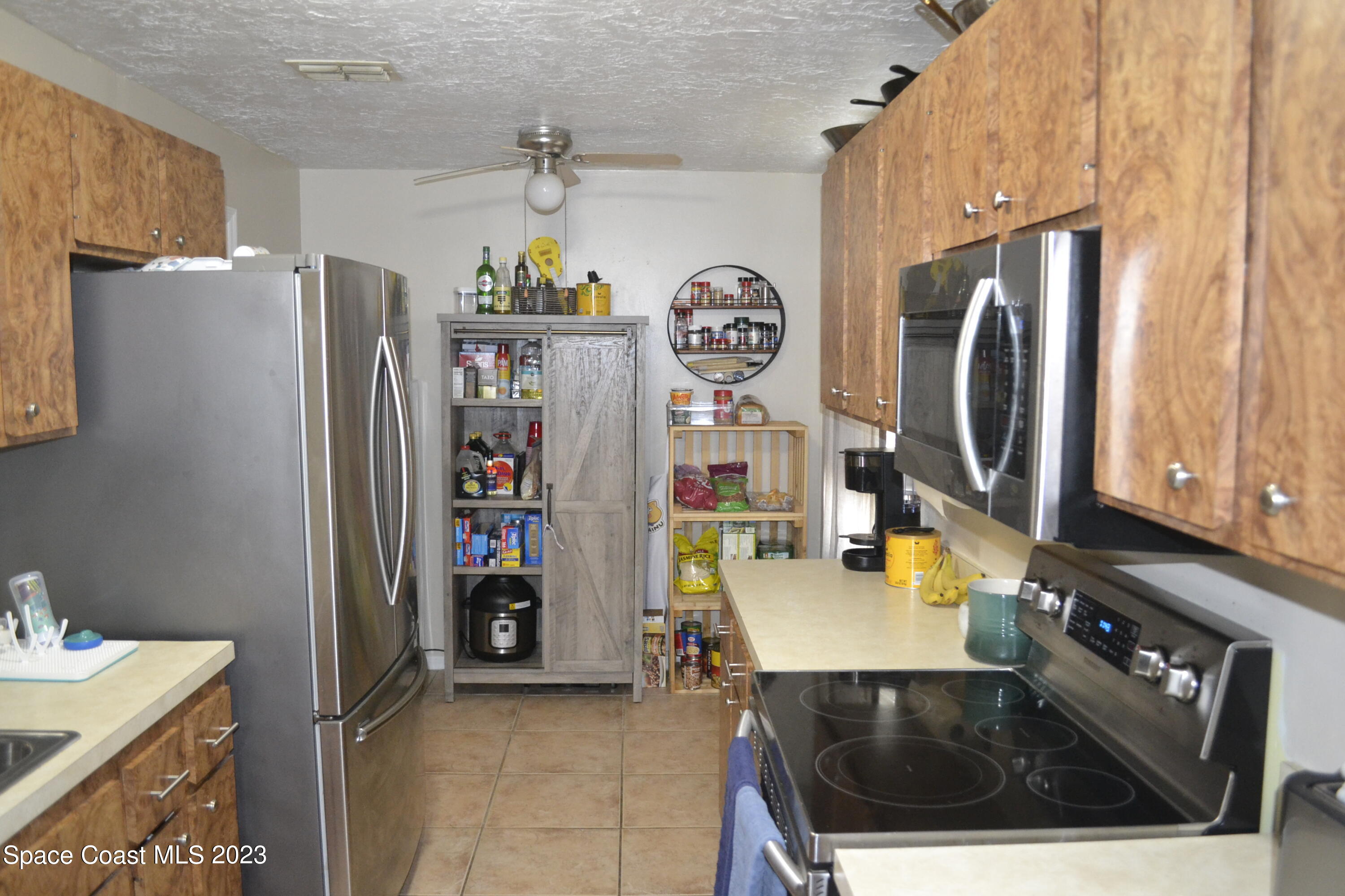 3910 Delespine Road Cocoa, FL 32927 - Photo 10 of 21 a kitchen with stainless steel appliances granite countertop a refrigerator and a stove