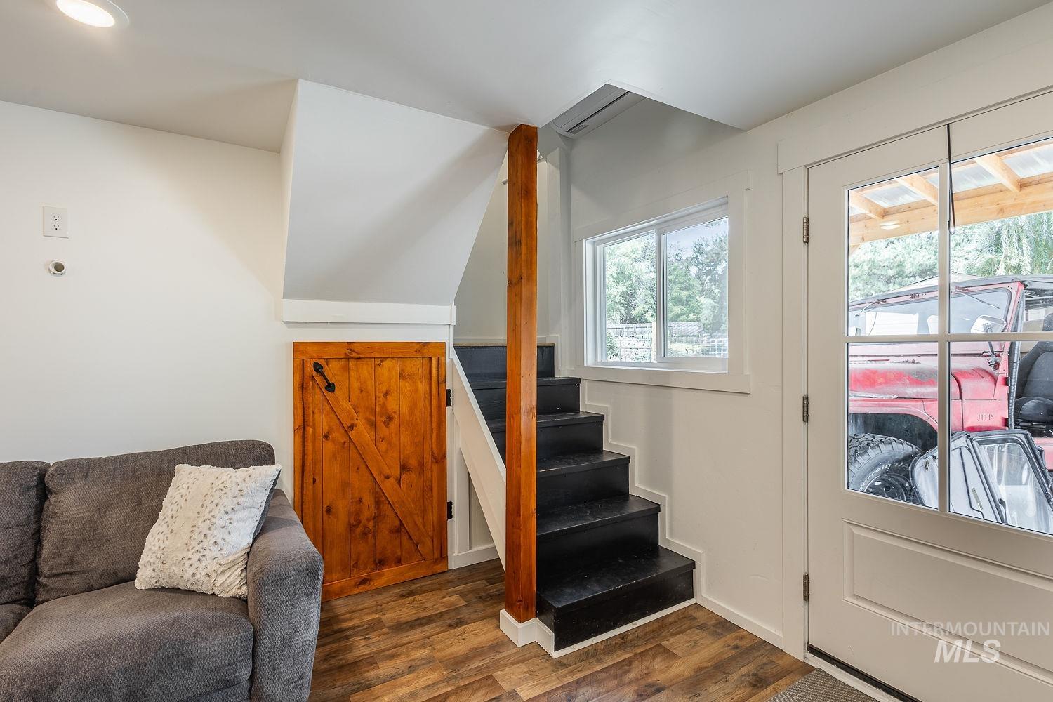 7166 South Cloverdale Road Boise, ID 83709 - Photo 30 of 50 Wood-finish flooring throughout, recessed lighting, and a white paneled door with glass insert