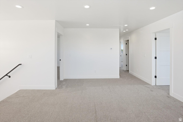 1315 West 3200 South, Unit 17 Perry, UT 84302 - Photo 25 of 58 Carpeted open-concept area featuring recessed lighting, white walls, and white trim