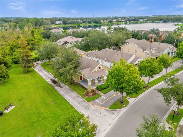 an aerial view of residential houses with outdoor space and street view
