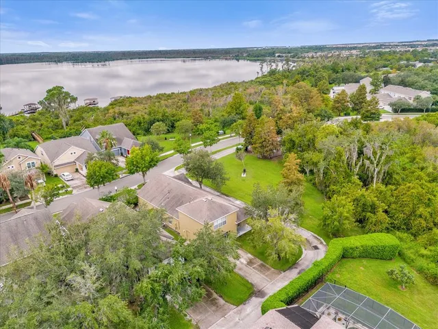 an aerial view of residential houses with outdoor space and river