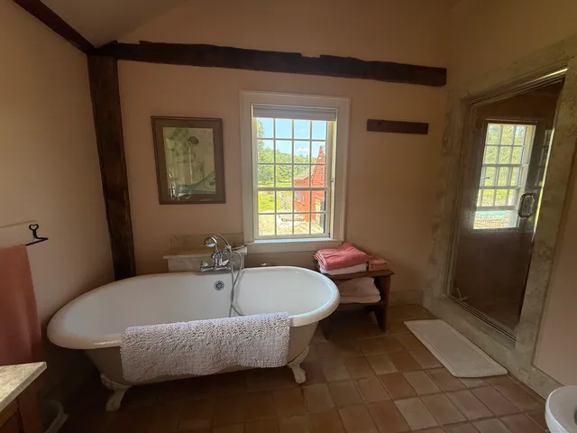 a spacious bathroom with a tub and shower