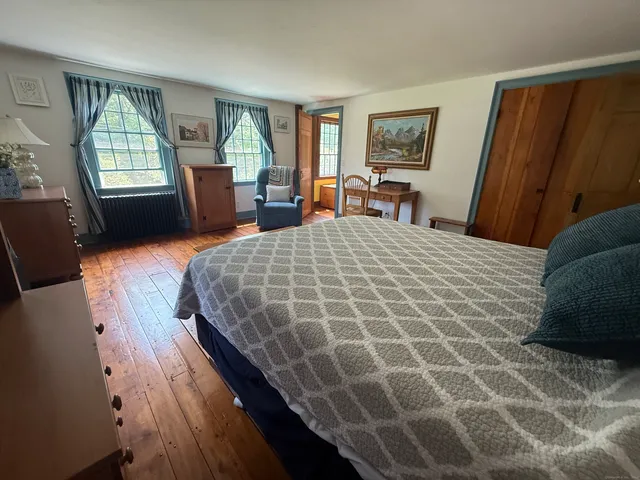 a bedroom with a large bed and a window