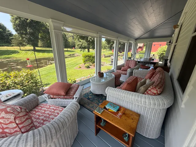 a living room with furniture and a floor to ceiling window