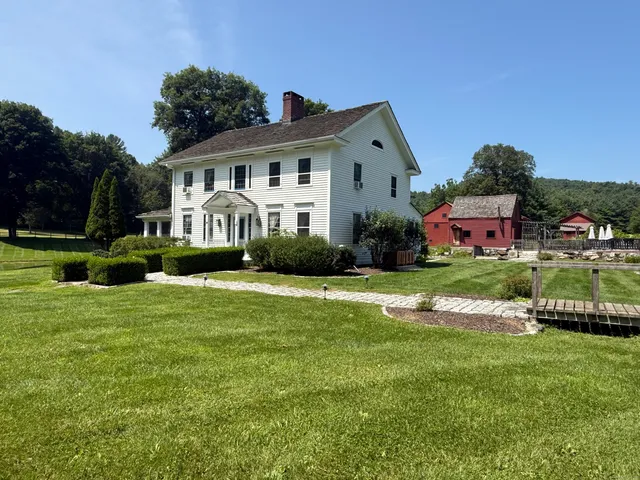 a front view of house with yard and green space