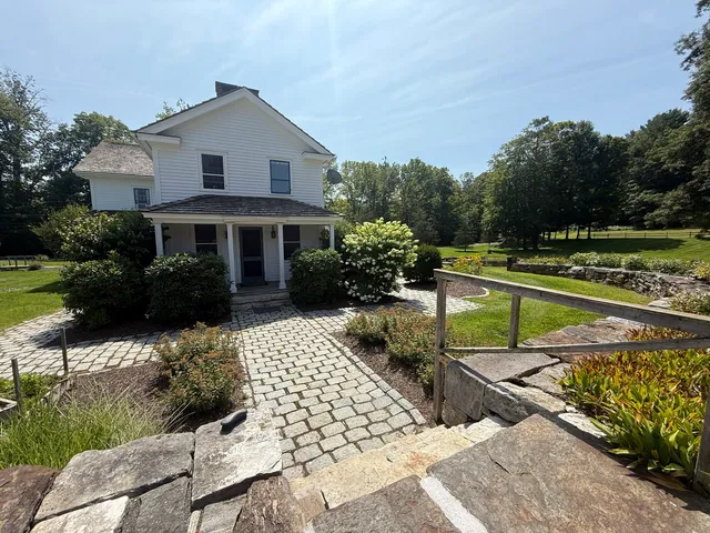 a house view with a sitting space and garden