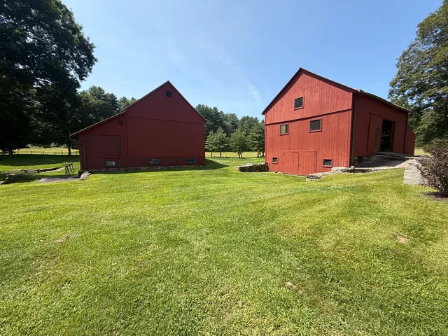 a house view with a garden and large trees