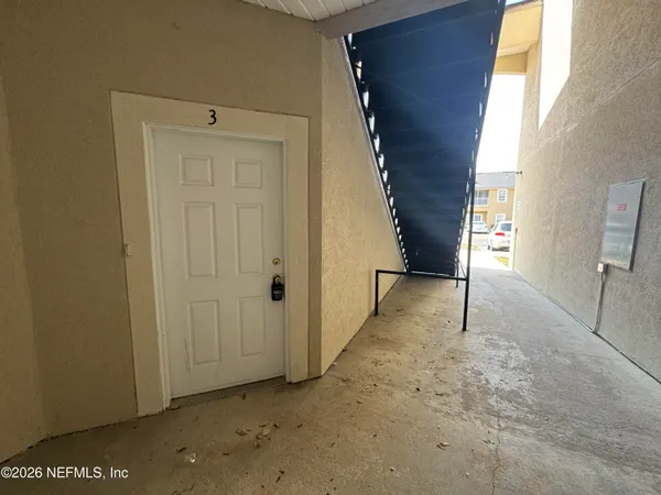 a view of an empty room with a window