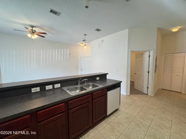 a kitchen that has a sink and cabinets