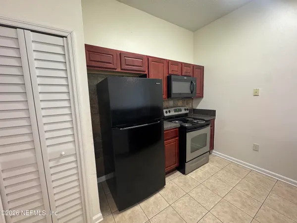 a kitchen with stainless steel appliances a refrigerator and a stove