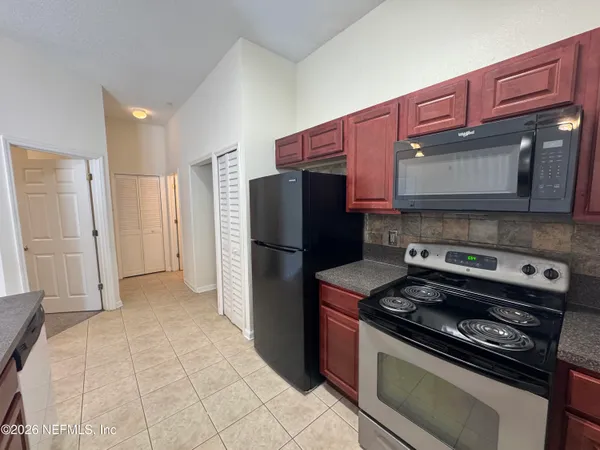 a kitchen with a refrigerator stove and microwave