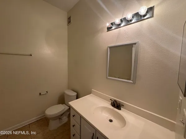 a bathroom with a sink vanity and a toilet