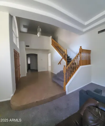 a hallway with couches and a window