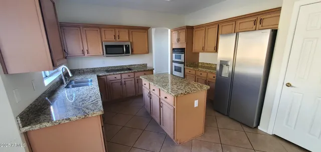 a kitchen with a stove a sink and a refrigerator