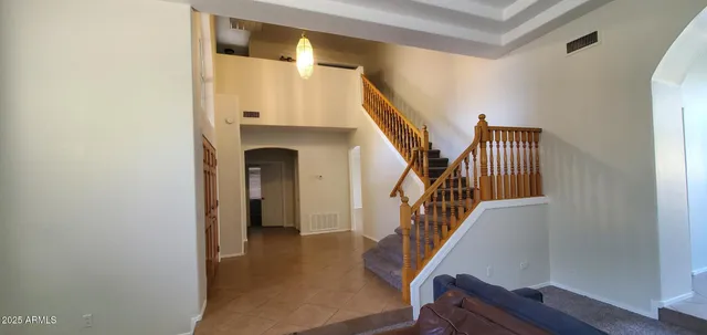 a room with water heater and wooden cabinets