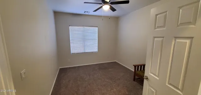 a view of staircase with railing and white walls