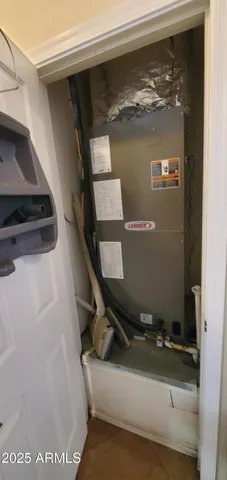 an empty room with a window and a ceiling fan