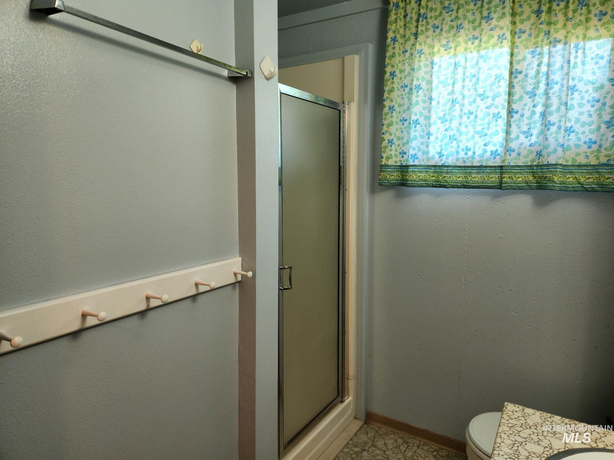 367 Woodland Road Kamiah, ID 83536 - Photo 26 of 49 Bathroom featuring a stall shower, a textured wall, and vanity