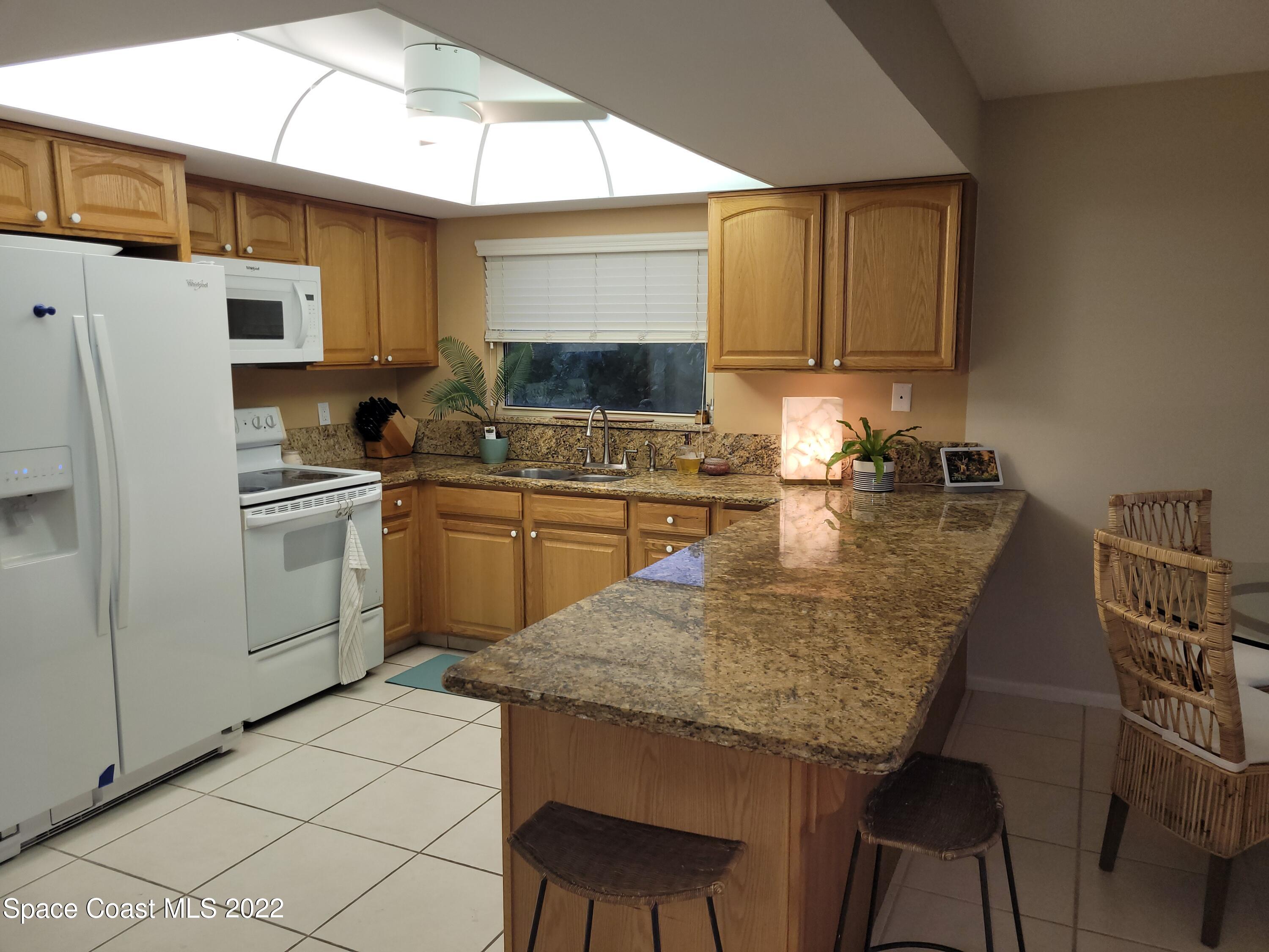 1251 South Atlantic Avenue, Unit 201 Cocoa Beach, FL 32931 - Photo 15 of 43 Large kitchen w/ breakfast bar