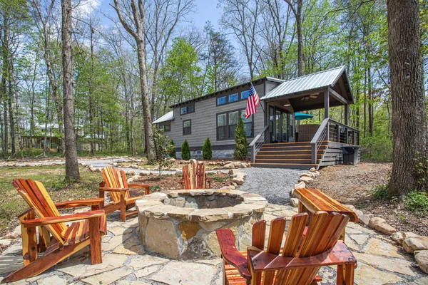 a view of backyard with seating space and trees