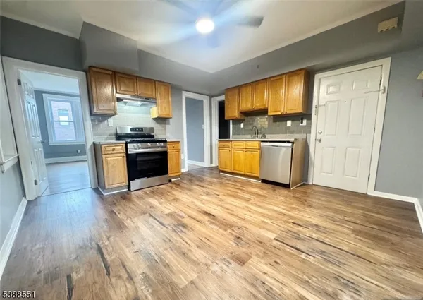 a view of a kitchen with a stove cabinets and wooden floor