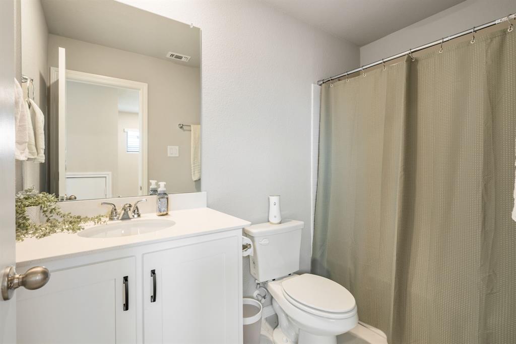 321 Pasture Drive Midlothian, TX 76065 - Photo 28 of 40 a bathroom with a sink a toilet a mirror and shower curtain