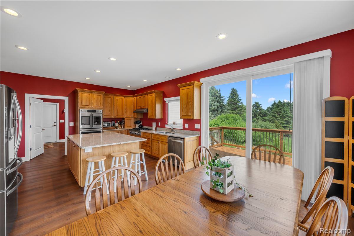 4266 McCandlish Road Grand Blanc, MI 48439 - Photo 18 of 68 Spacious kitchen and dining area featuring wood-finish flooring and red walls