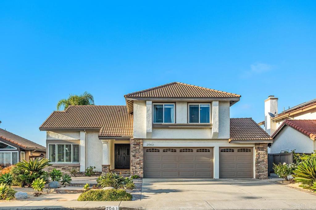 2063 Wandering Road Encinitas, CA 92024 - Photo 1 of 23 a front view of a house with garden