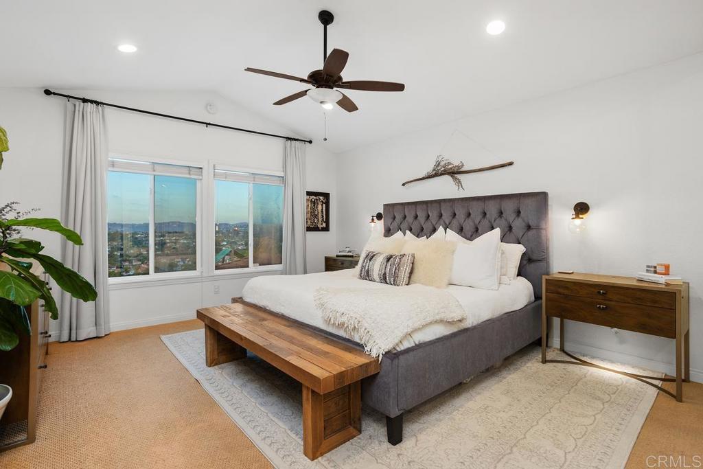 2063 Wandering Road Encinitas, CA 92024 - Photo 11 of 23 a spacious bedroom with a bed and a potted plant