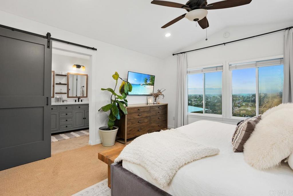 2063 Wandering Road Encinitas, CA 92024 - Photo 12 of 23 a bedroom with a bed potted plant and a large window