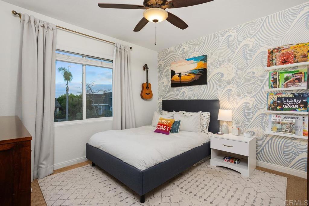 2063 Wandering Road Encinitas, CA 92024 - Photo 14 of 23 a bedroom with a bed a couch and a window