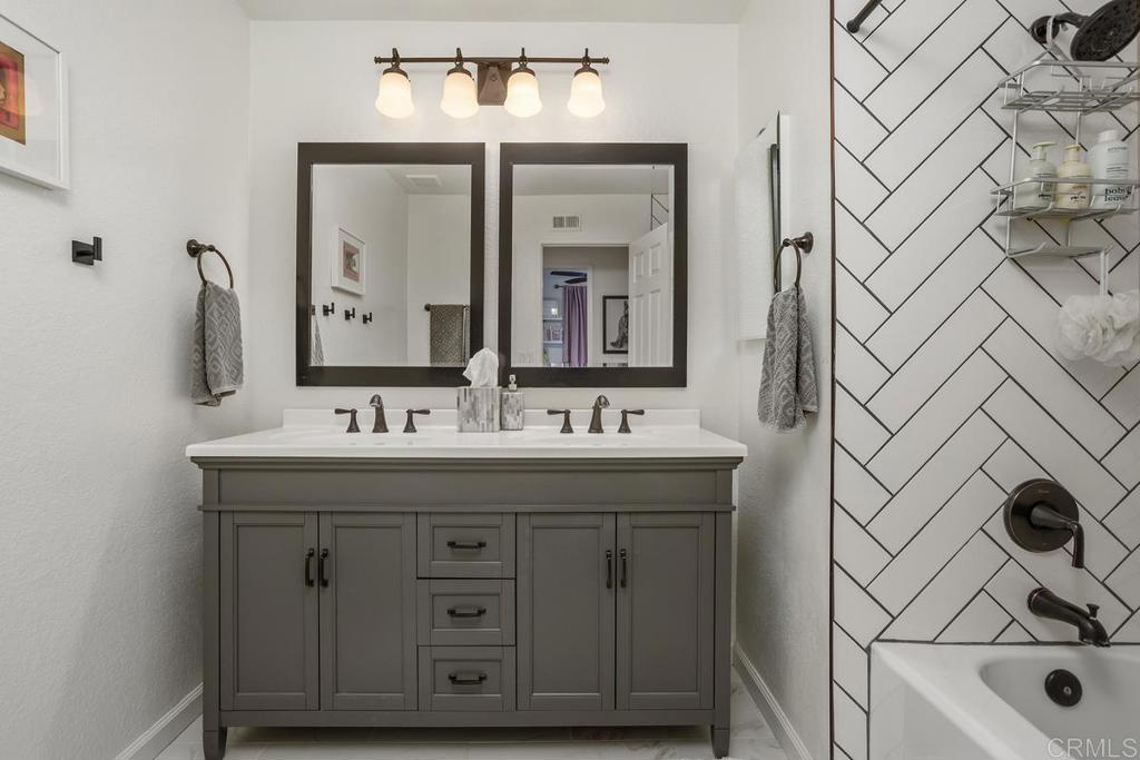 2063 Wandering Road Encinitas, CA 92024 - Photo 16 of 23 a bathroom with a sink and a mirror