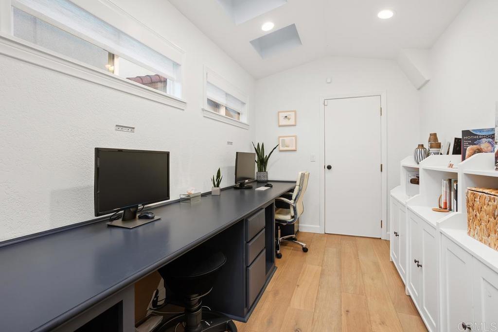 2063 Wandering Road Encinitas, CA 92024 - Photo 18 of 23 a view of a workspace with furniture and wooden floor