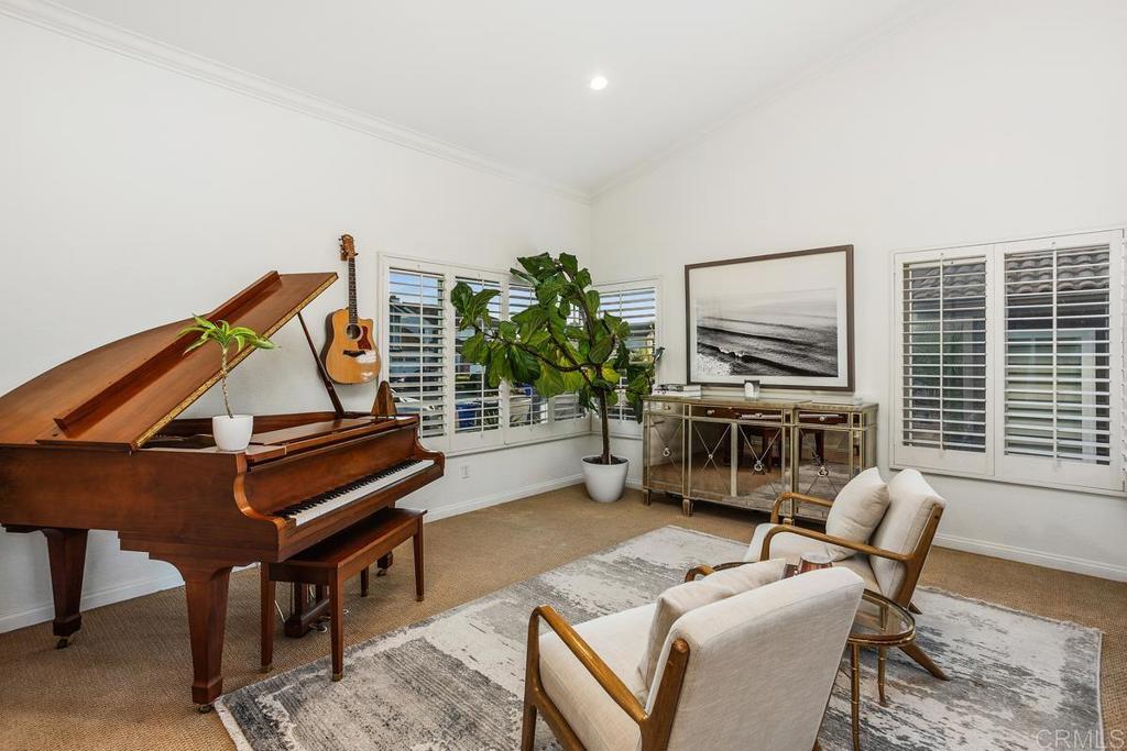2063 Wandering Road Encinitas, CA 92024 - Photo 3 of 23 a living room with furniture a piano and a potted plant