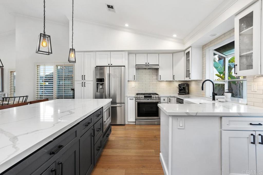 2063 Wandering Road Encinitas, CA 92024 - Photo 7 of 23 a kitchen with stainless steel appliances granite countertop a sink a stove and a refrigerator