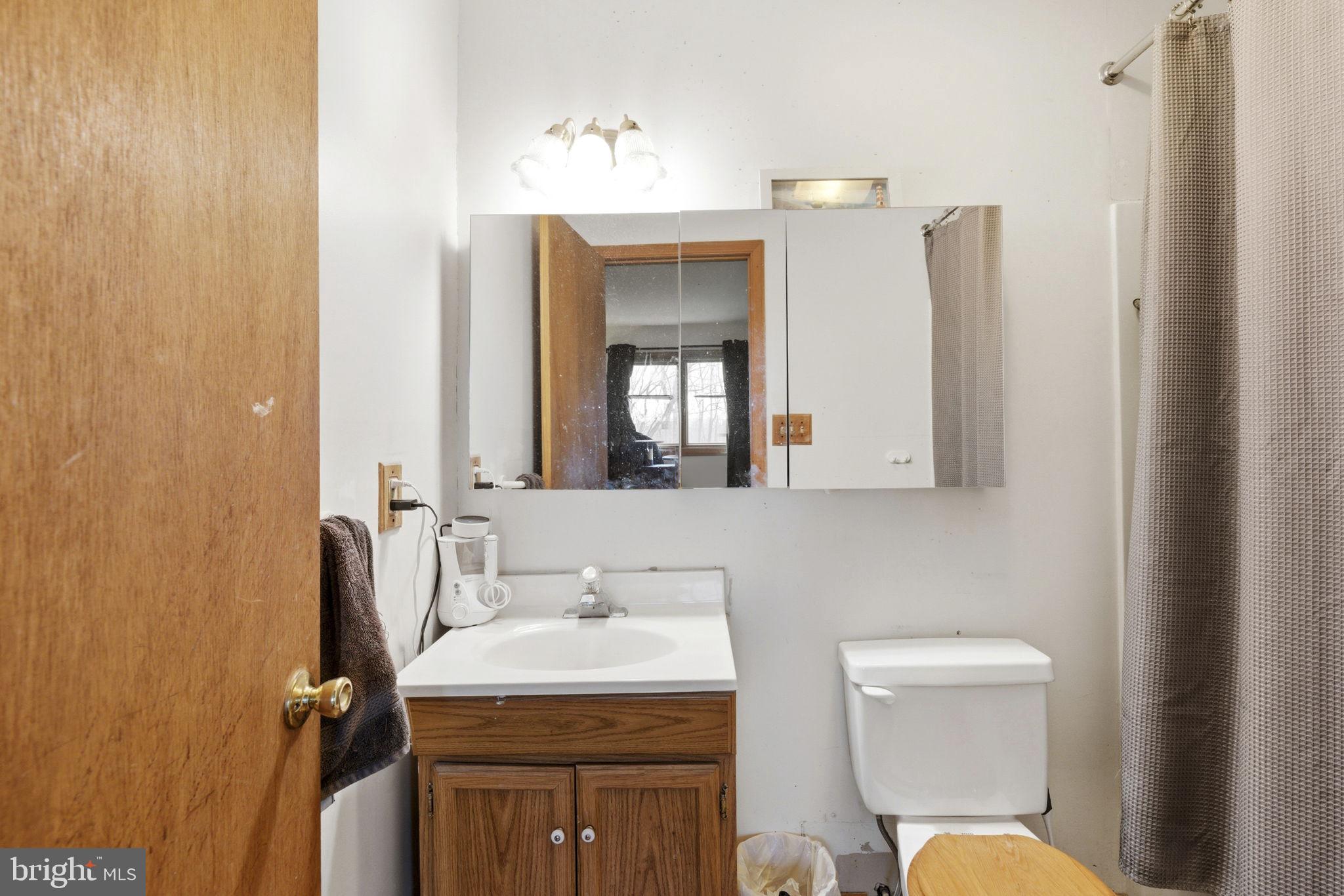 1655 Old Elk Neck Road Elkton, MD 21921 - Photo 13 of 43 a bathroom with a toilet sink and mirror