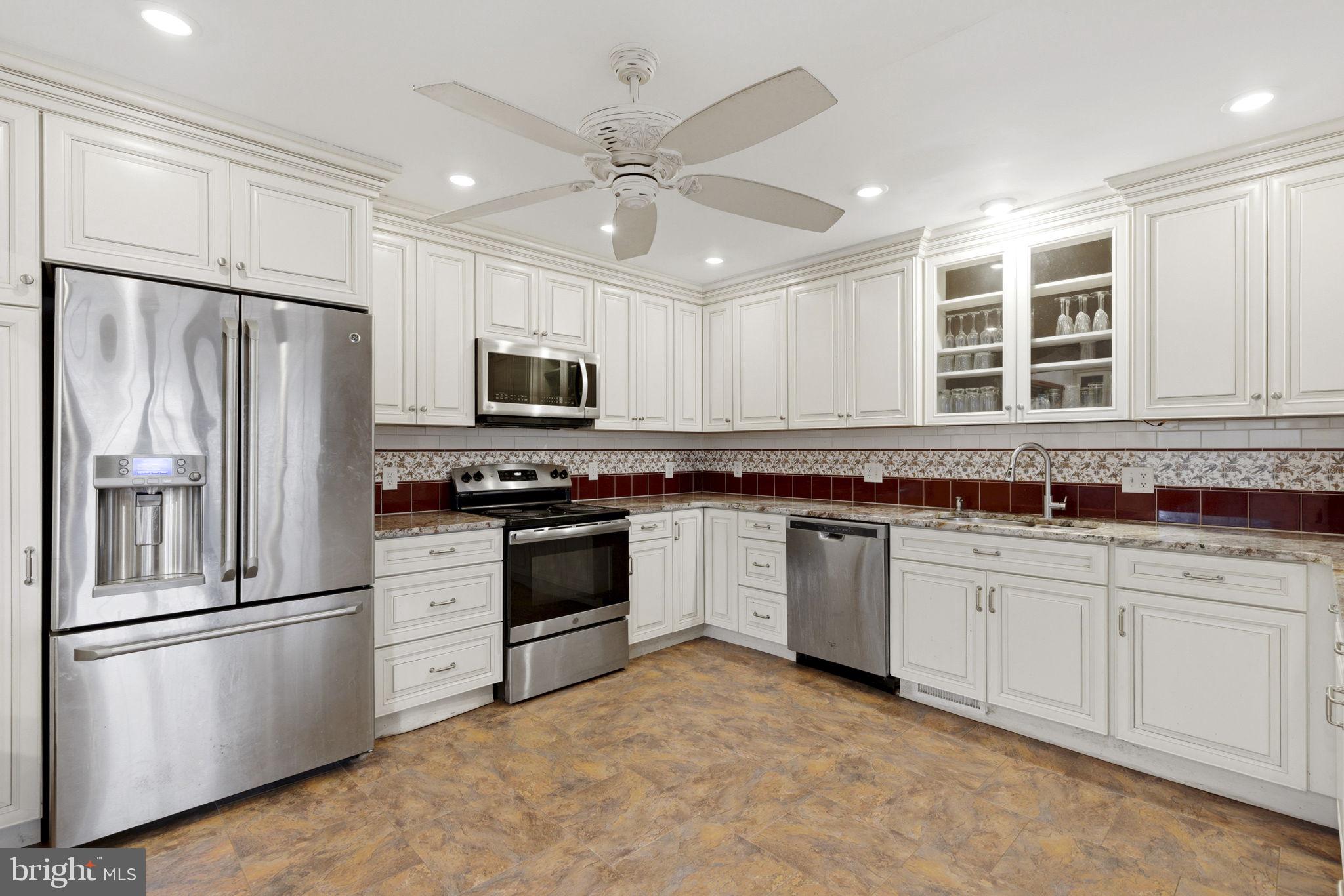 1655 Old Elk Neck Road Elkton, MD 21921 - Photo 8 of 43 a kitchen with granite countertop a refrigerator oven a sink cabinets and stainless steel appliances