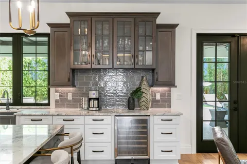 a kitchen with granite countertop a sink counter top space and living room