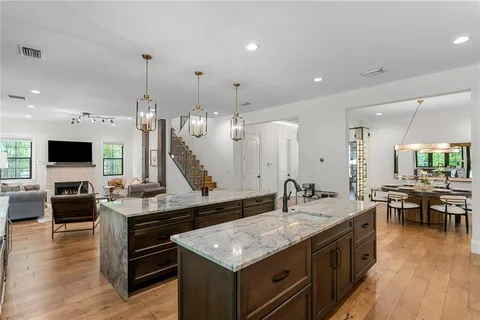 a kitchen with stainless steel appliances granite countertop a sink stove and refrigerator