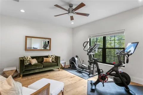 a spacious bedroom with a bed and a flat screen tv