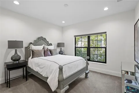 a bedroom with a large bed and a window