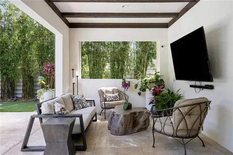 a view of a house with swimming pool and sitting area