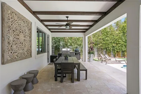 a view of a backyard with swimming pool and furniture