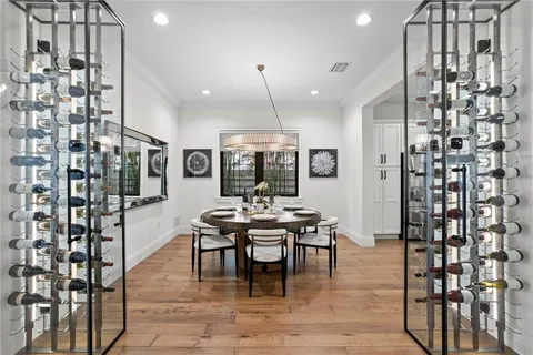 a dining room with furniture a chandelier and wooden floor
