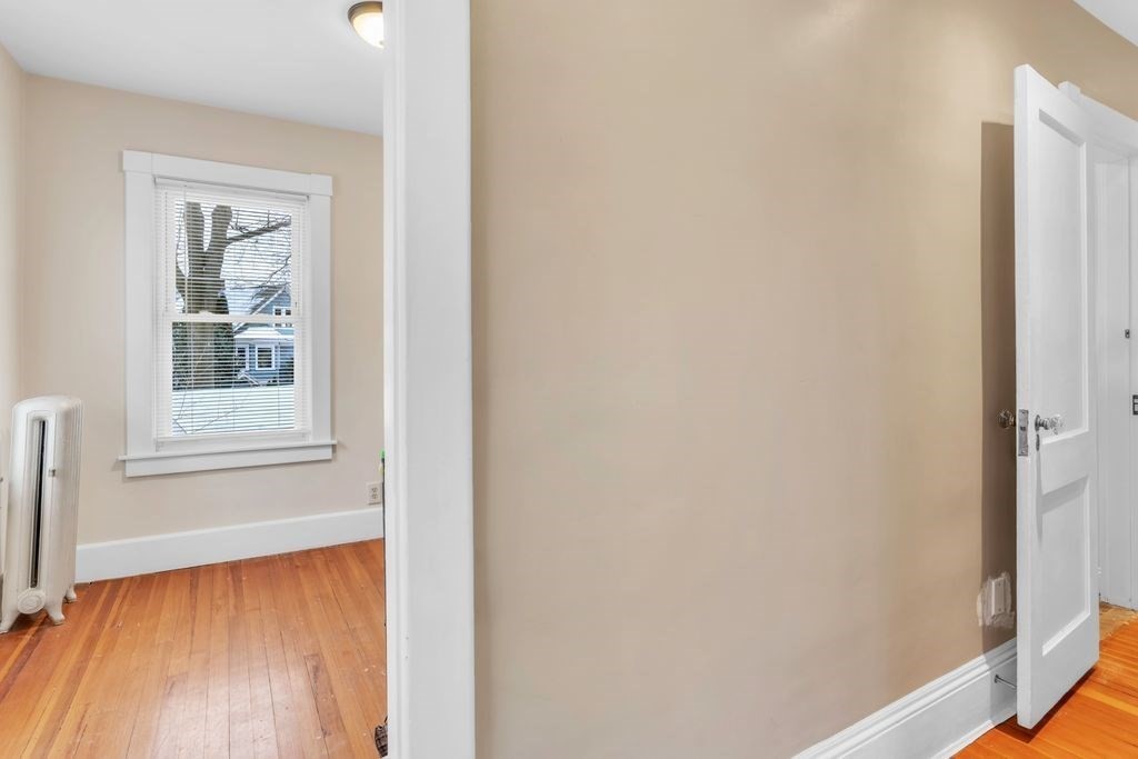754 White Street Springfield, MA 01108 - Photo 25 of 41 a view of an empty room with wooden floor and a window