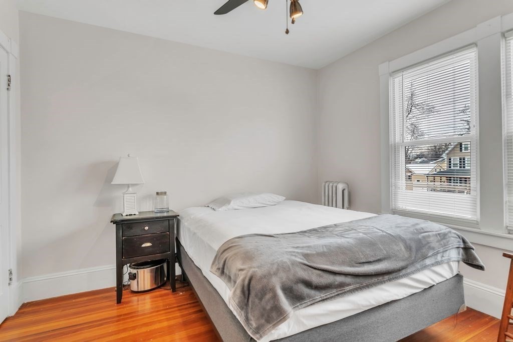 754 White Street Springfield, MA 01108 - Photo 26 of 41 a bedroom with a bed and wooden floor