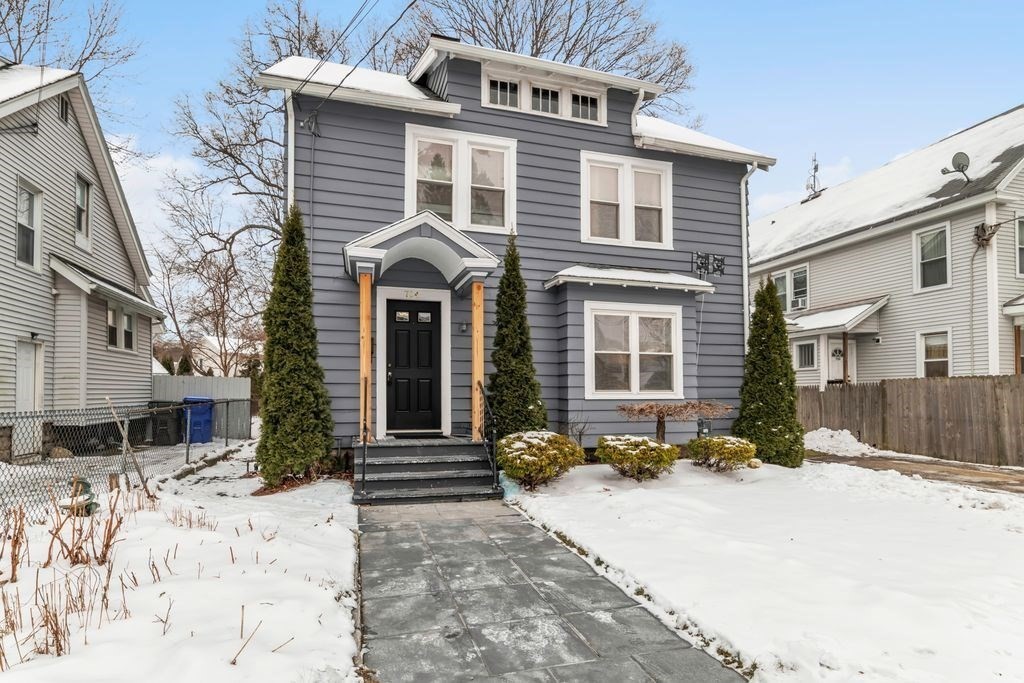 754 White Street Springfield, MA 01108 - Photo 3 of 41 a front view of a house with a yard covered in snow