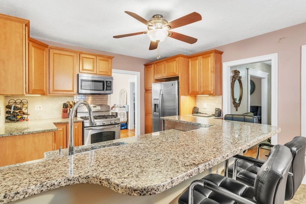 754 White Street Springfield, MA 01108 - Photo 4 of 41 a kitchen with stainless steel appliances granite countertop a stove refrigerator and cabinets